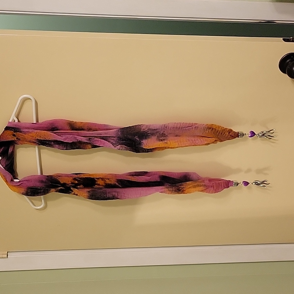 Pink and black swirly print long scarf with silver metal and purple tassels